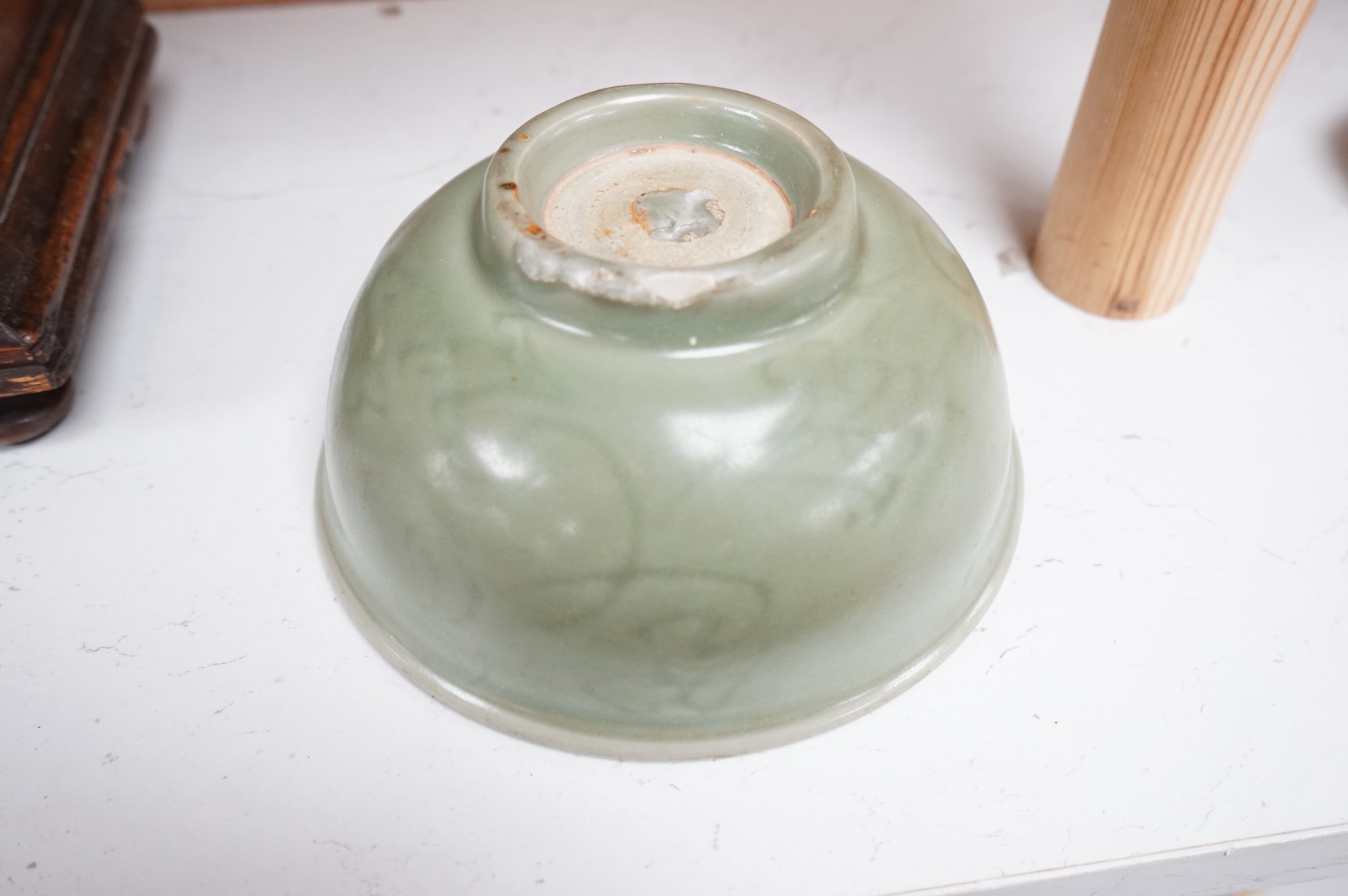 A Chinese celadon glazed bowl with incised decoration, 16cm diameter. Condition - good